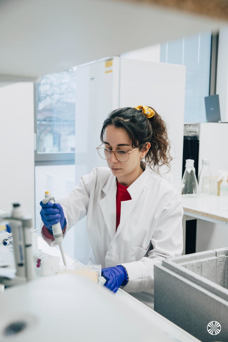 Nadège working with a pipette at the laboratory bench
